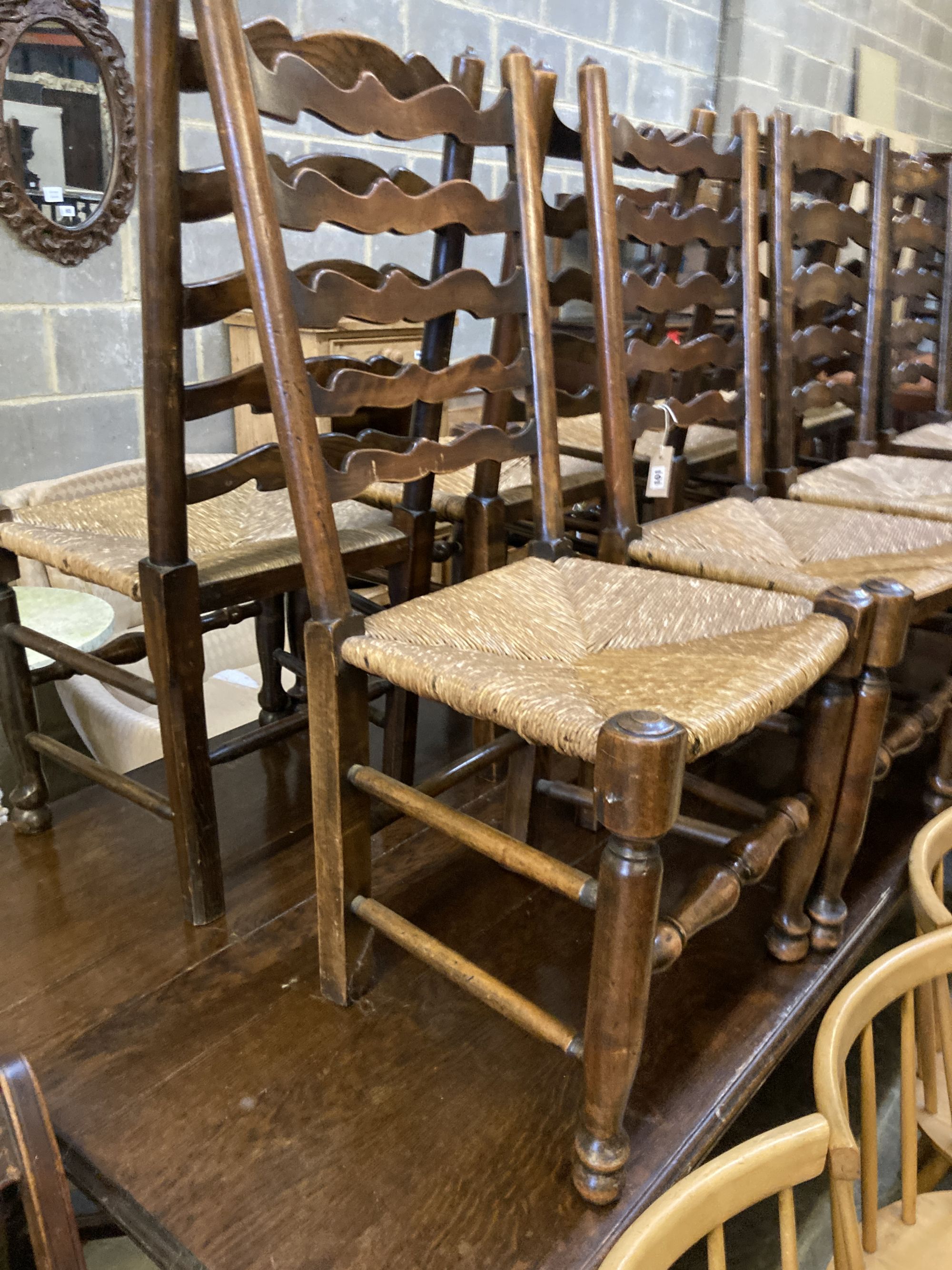 A harlequin set of nine early 19th century ash rush seated ladderback dining chairs (5 and 4)